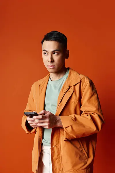 Handsome Asian Man Stylish Orange Jacket Holding Cell Phone Orange — Stock Photo, Image