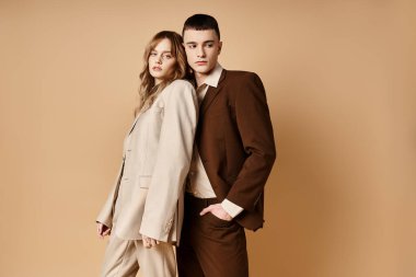 Güzel kız arkadaşının yanında poz veren güler yüzlü yakışıklı genç adam kameraya bakıyor.