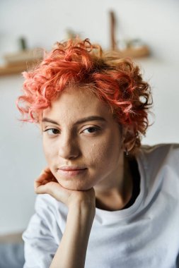 Canlı kızıl saçlı, yatakta oturup boş zamanlarında kameraya bakan güzel, tuhaf bir insan.