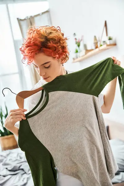 Appealing Red Haired Extravagant Person Picking Stylish Clothes Rack Home — Stock Photo, Image