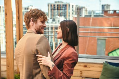 A man and a woman, standing side by side, embodying unity and diversity with their contrasting features and body language clipart