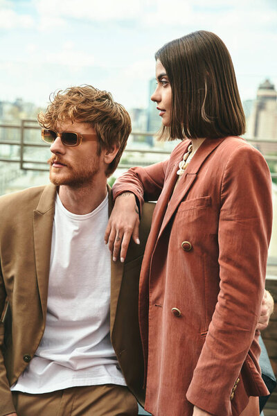 A man and a woman stand side by side, exuding a sense of connection, unity, and companionship in their posture and gaze