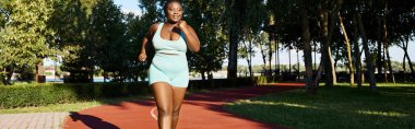 Curvy African American woman elegantly runs outdoors, motivation and sport clipart