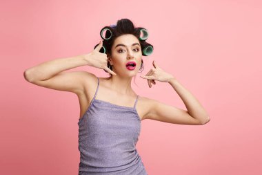 A woman with curlers in her hair, enhancing her natural beauty with makeup. clipart