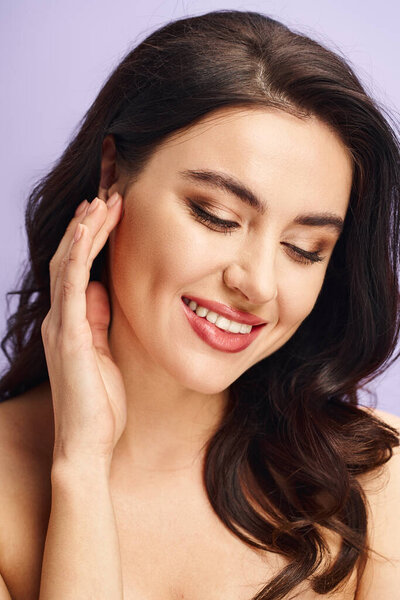A woman with natural beauty smiles while with makeup.
