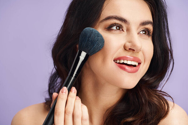 A woman gracefully holds a makeup brush, enhancing her natural beauty.