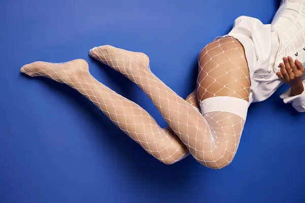 Stylish Young Woman Fishnet Stockings Lying Gracefully Ground White Dress — Stok fotoğraf