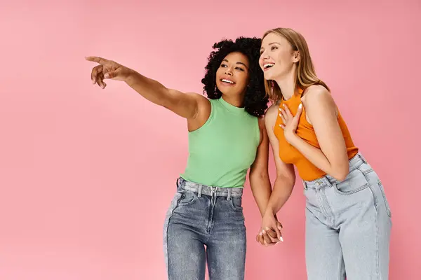Two Attractive Diverse Women Pointing Something Standing Next Each Other — Stock Photo, Image