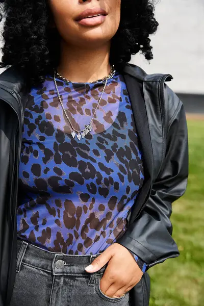 stock image A woman with diverse ethnicity wearing a blue top and black jacket.