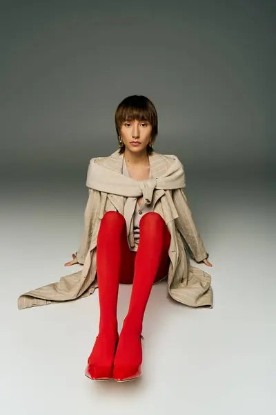 Young Woman Short Hair Elegantly Sits Floor Wearing Striking Red — Stock Photo, Image