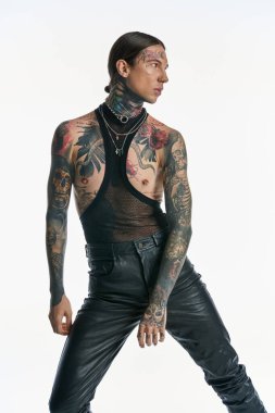 A young man displaying intricate tattoos and various piercings on his chest, exuding a sense of self-expression and artistry. clipart