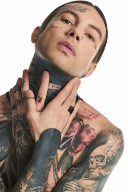 A young stylish man with an array of intricate tattoos adorning his body, showcasing his unique sense of artistry and self-expression. clipart