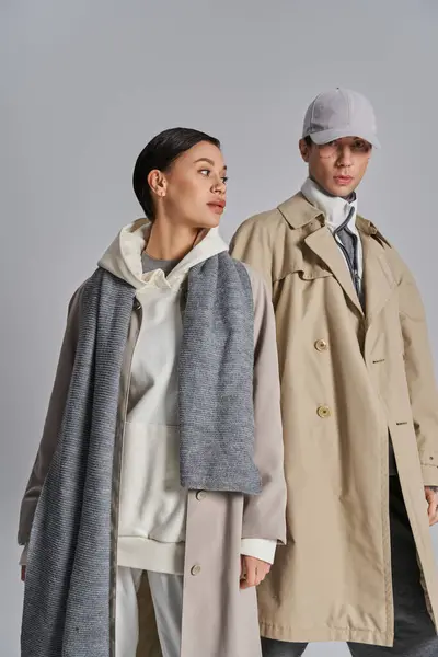 Young Stylish Couple Wearing Trench Coats Hats Studio Setting Grey — Stock Photo, Image
