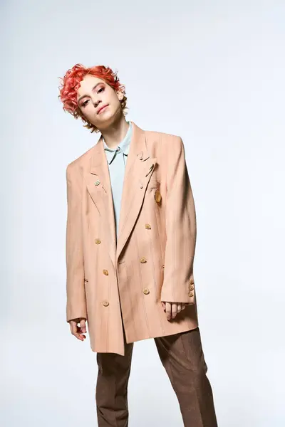 stock image Extraordinary woman with red hair dons a refined tan suit.