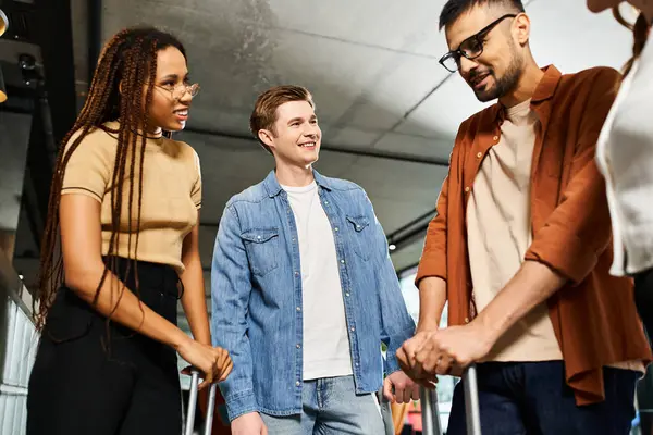 stock image Multicultural businesspeople in casual attire stand united, showcasing camaraderie and teamwork in a hotel lobby.