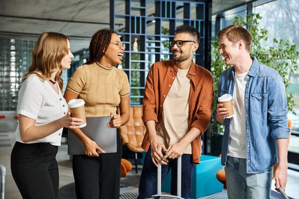 Multicultural colleagues in casual attire stand together in a hotel lobby during a corporate trip, showcasing unity.