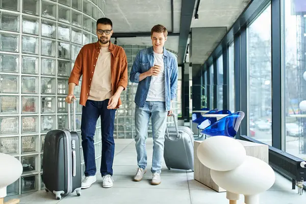 stock image Two colleagues navigate the airport, each with luggage in tow, as they embark on a shared corporate trip.