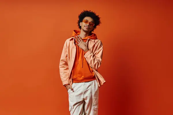 Trendy Curly African American Man Poses Orange Jacket White Pants — ストック写真