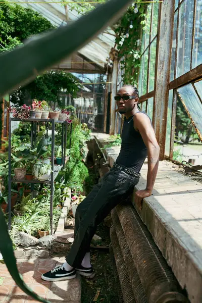 African American Man Dapper Style Sitting Ledge Vibrant Greenhouse — Stockfoto