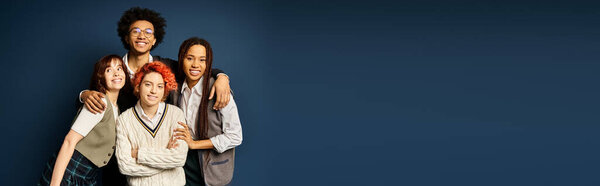 A group of young multicultural friends, including a nonbinary person, stand together in stylish attire against a dark blue background.