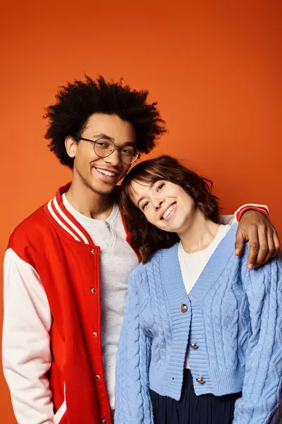 stock image A young multicultural friends stands elegantly in stylish attire in a studio setting.