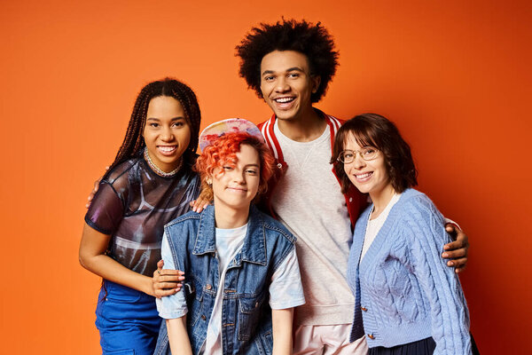 Young interracial friends standing together in stylish attire in a studio setting.