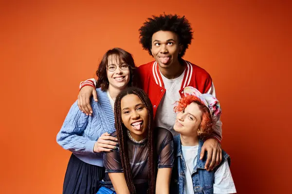 stock image A diverse group of young friends, including a nonbinary individual, standing together in stylish attire in a studio setting.