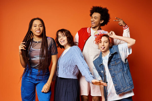 A group of young multicultural friends, including a nonbinary person, stand side by side in stylish attire in a studio setting.