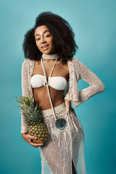 stock image Young African American woman in bikini holding a pineapple.