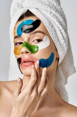 A stunning young woman with a towel wrapped around her head with eye patches on her face, enhancing her natural beauty. clipart