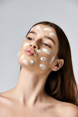 A young woman with a white cream delicately adorns her face, exuding an air of mystery and elegance. clipart