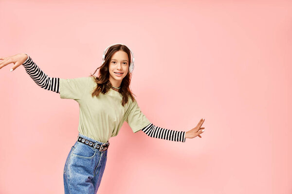 Стильная девушка-подросток, энергично позирующая в ярко-зеленой рубашке и синих джинсах.