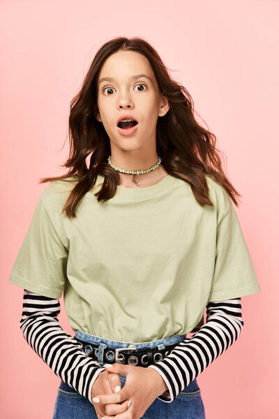 A stylish teenage girl with vibrant attire looks surprised.