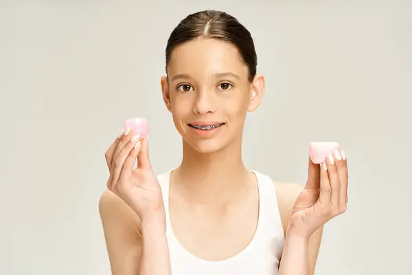 Stylish Teenage Girl Vibrant Attire Gracefully Holds Cream Her Hands — Fotografia de Stock