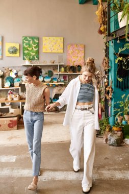 Lesbian couple walk among vibrant art. clipart