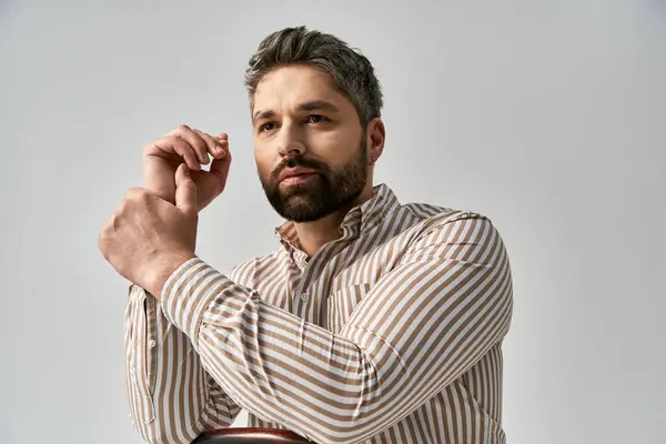 Stylish Man Beard Strikes Pose Striped Shirt Gray Studio Backdrop — Foto Stock