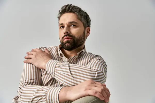 Stylish Man Beard Striking Pose Striped Shirt Grey Studio Backdrop — Foto Stock