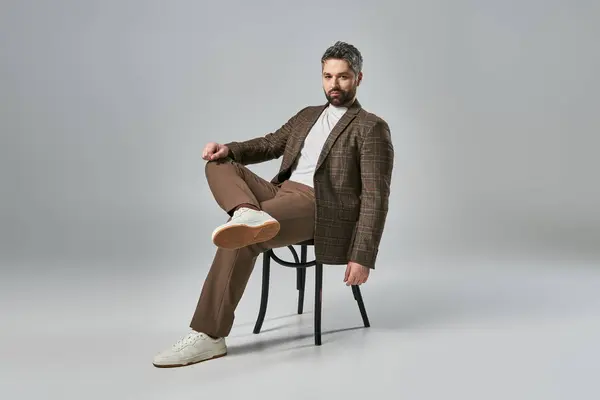 Stylish Man Beard Sits Chair Crossing His Legs Elegantly Fashion — Stok fotoğraf