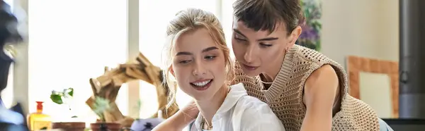 Stock image Two women engage with a piano in an art studio.