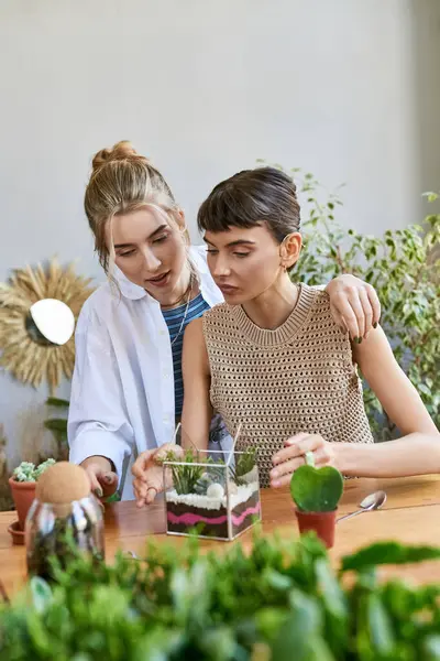 stock image Lesbian couple enjoying a creative moment at a table in an art studio.