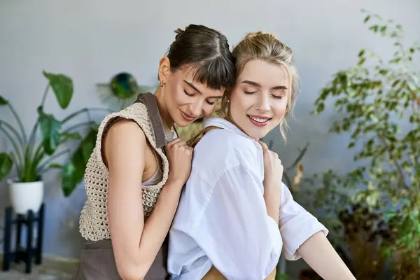 Two Women Sharing Heartfelt Hug Art Filled Space — Stockfoto
