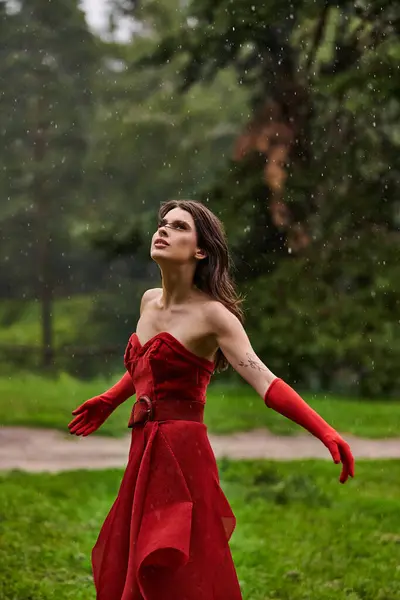 Stunning Young Woman Striking Red Dress Stands Gracefully Rain Capturing — Photo