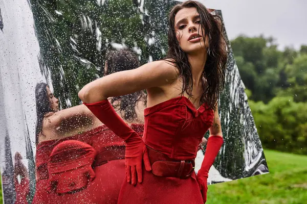 Radiant Woman Vibrant Red Dress Stands Gracefully Mirror Exuding Elegance — Stok fotoğraf