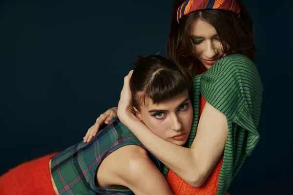 stock image Two young women in a studio hugging each other with smiles.