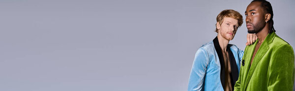 Two elegant multicultural men posing stylishly together.