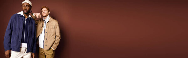 Two multicultural men with stylish fashion stand confidently side by side.