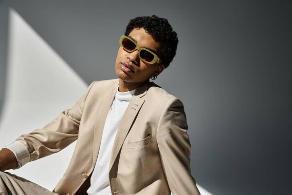 African American man in tan suit and sunglasses.