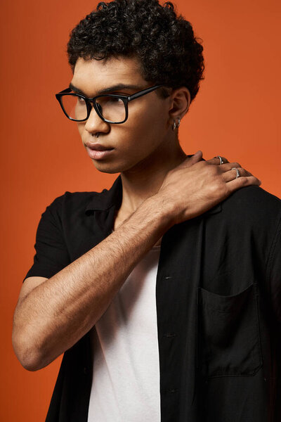 Handsome African American man in stylish black glasses and shirt.