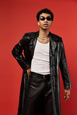 Young man in leather coat striking a pose clipart