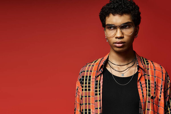 Handsome African American man in glasses and plaid shirt.